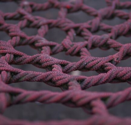 a close up of a red rope with a black background