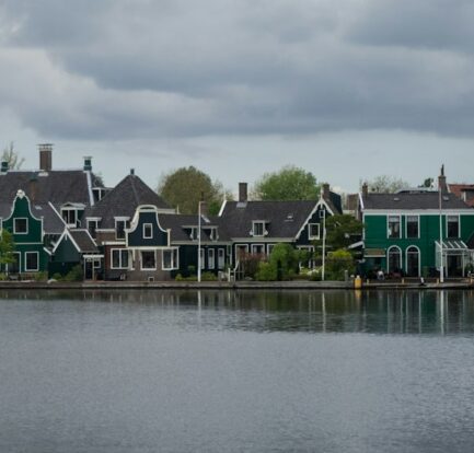 A body of water with houses in the background
